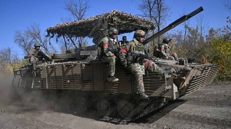 FILE PHOTO: Russian troops riding atop an armored vehicle.
