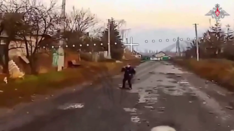 Man makes sign of cross to show Russian drone he is civilian (MOD VIDEO)