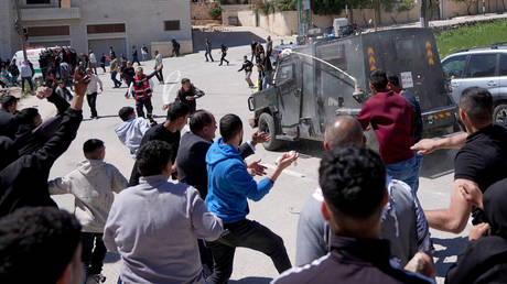 Israeli forces raid a funeral ceremony held for Palestinians killed in attacks by Israeli settlers in Ramallah, West Bank, Palestine on April 22, 2026