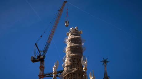 The upper arm of the cross being lifted onto the Tower of Jesus Christ at the Sagrada Familia, Barcelona, Spain, February 20, 2026