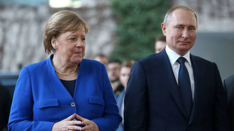 Angela Merkel (L) greets Vladimir Putin at the German federal Chancellery in Berlin, Germany, January 19, 2020