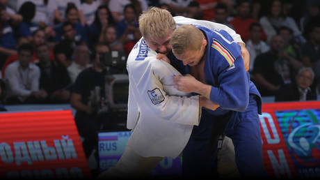 FILE PHOTO: Russia's Sergei Samoylovich, in white, and Germany's Dmitry Peters during the bout for 3rd place in the men's 100kg division at the international Grand Slam Judo tournament in Moscow.